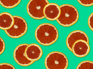 Creative pattern made of red oranges. top view of colorful fruit pattern of fresh red orange slices on blue colorful background. 