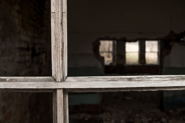 an old wooden window frame without glass in an abandoned old house