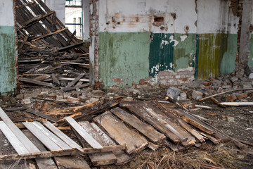 collapsed ceiling and part of the wooden floor in an old abandoned building