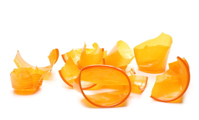 Chopped orange plastic cups isolated on white background