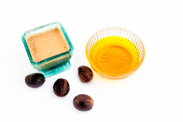 Face mask or face pack to prevent acne and to fill the pores isolated on white i.e. Nutmeg powder well mixed with some raw honey in a glass bowl along with some raw nutmeg and honey.