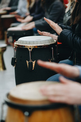 a large group of people play with African drums for the first time