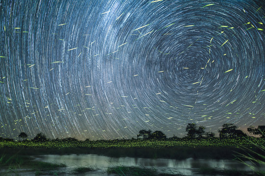 Star trail over river at night