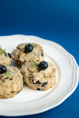 Fresh Baked Raspberry and Blueberry oatmeal wheat Scones set on Blue Background.