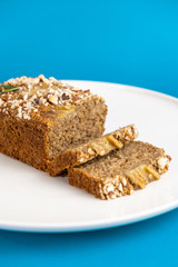 Almond bread loaf with Almond diced and Banana sliced set on Blue Background.