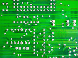 Close-up of printed electronic circuit board with processor and many integrated electrical...