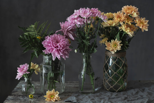 purple and yellow flowers on vases