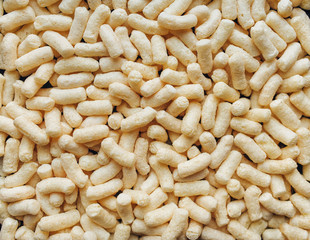 Background of yellow corn sticks. The view from the top. Dietary breakfast.