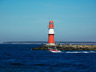 The red lighthouse at the harbor entrance