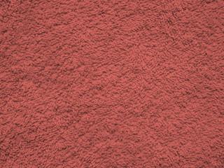 Close-up of teal textile texture, background wallpaper. Texture of Living Coral knitted fabric. Surface of fleece towel. Texture of green fabric textile upholstery of furniture. High-quality macro.