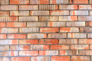 Red vintage brick wall. Old broken industrial texture. Background. Grunge street exterior