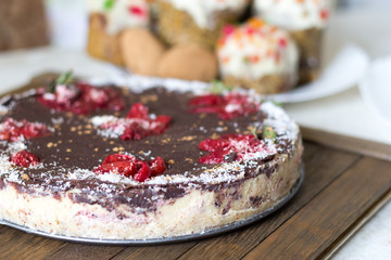 Healthy sweets concept. Raw foods homemade cake on wood tray.