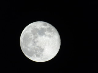 Genova, Italy - 03/22/2019: An amazing photography of the full moon over the city of Genova by...