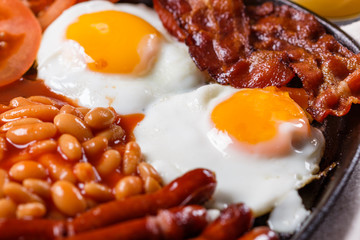 delicious English breakfast on a dark rustic background