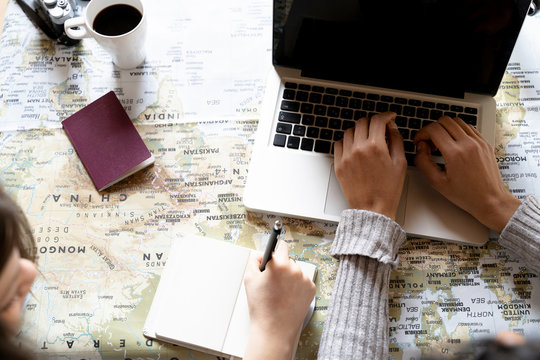 Friends using laptop, planning vacation