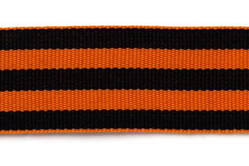 St. George ribbon on a white background. Black orange ribbon close up on a white background.