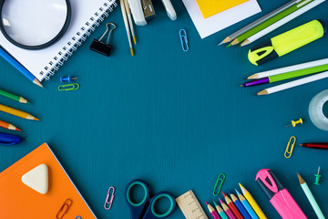 School supplies on blue background. Top view. Copy space.