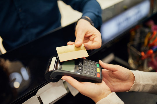 Close-up Of Customer Paying Cashless With Credit Card In A Shop