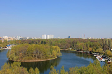 Fototapeta premium Panoramic view of the round pond and round island in the center of the pond in Izmailovsky Park in Moscow Russia on a spring day