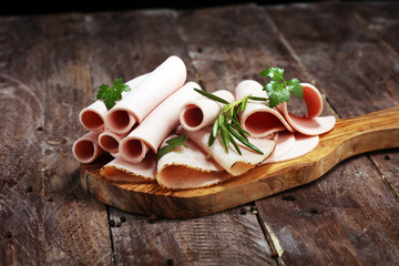Sliced ham on wooden background. Fresh prosciutto cotto. Pork ham sliced.