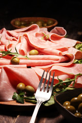 Sliced ham on wooden background. Fresh prosciutto. Pork ham proscuitto sliced.