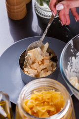 young woman in a gray aprons preparing Hawaiian salad