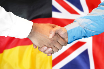 Business handshake on the background of two flags. Men handshake on the background of the Germany...