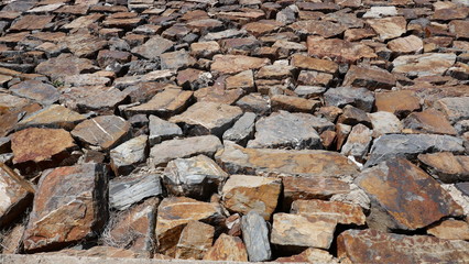 Natural stones, quarry stones as a protective wall. Background, texture, closeup, full frame