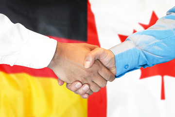Business handshake on the background of two flags. Men handshake on the background of the Germany...