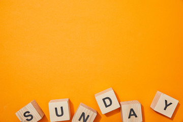 top view of wooden cubes with letters on orange surface