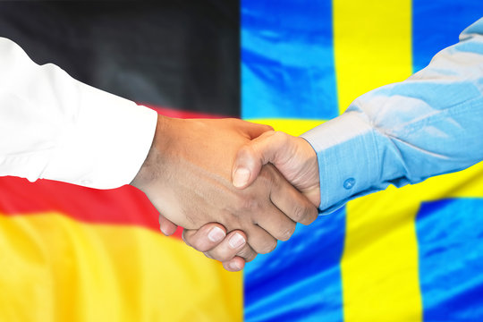 Business handshake on the background of two flags. Men handshake on the background of the Germany and Sweden flag. Support concept