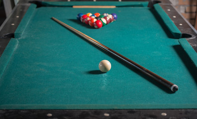 Billiards balls and cue on billiards table. Billiard sport concept