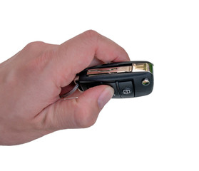 Hand holding car key isolated on white background