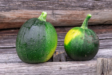Fresh zucchini on wooden background