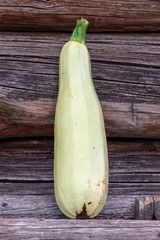 Fresh zucchini on wooden background