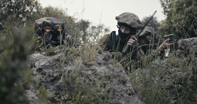 Israeli soldiers in a surveillance and reconnaissance mission using binoculars