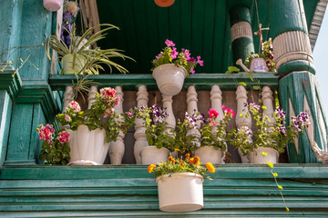 Flowers on the balcony of a luxury house in a classic style. Architecture