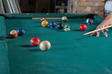 Billiards balls and cue on billiards table. Billiard sport concept