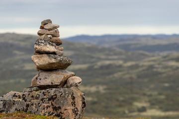Stones stacked for Norwegian fairytale trolls. Relief and texture of stone with patterns and moss. Stone natural background. Stone with Moss. Stones boulders covered with moss.