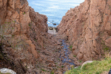 river meets ocean along a rocky shoreline with heavy water flow in a forest area, Motion river