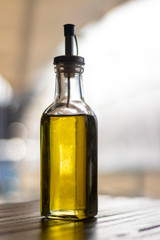 Olive oil bottle still-life over grey background