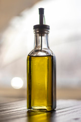 Olive oil bottle still-life over grey background