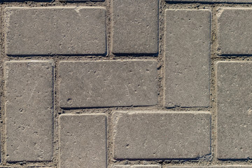 Grey paving stones as background. Grey granite cobblestone. Close-up. Top view.