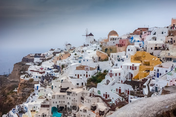 View of colorful and pictoresque village of Oia on a rare rainy day