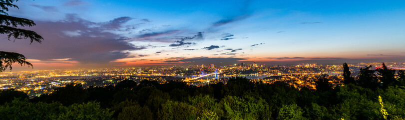 Fototapeta na wymiar Istanbul Bosphorus Bridge at sunset. 15th July Martyrs Bridge. Night view from Camlica Hill. Istanbul, Turkey..