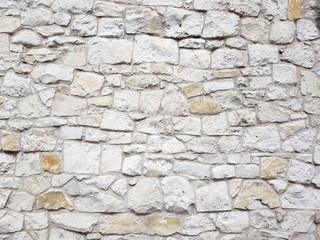 Old bright white pattern stone wall texture.