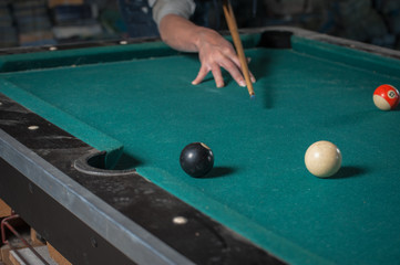 Billiards balls and cue on billiards table. Billiard sport concept