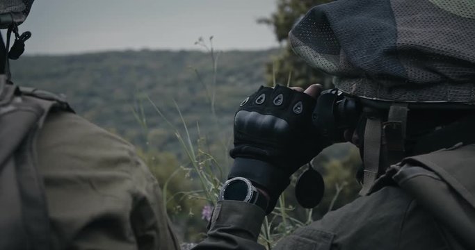 Israeli soldiers in a surveillance and reconnaissance mission using binoculars