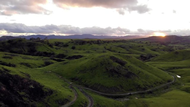 Aerial view over lush, green hills in California