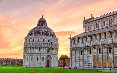 Obraz premium Pisa, Italy. Beautiful sunset view of Pisa Baptistery of St. John, Battistero di San Giovanni. Roman Catholic ecclesiastical building in Pisa. UNESCO world heritage site. Iconic travel landmark.